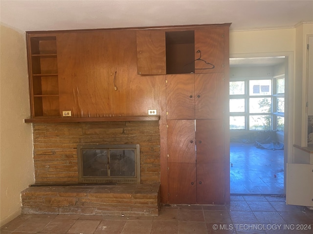 unfurnished living room with crown molding and a fireplace