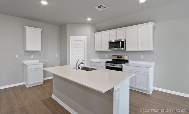 kitchen featuring stainless steel appliances, white cabinetry, light wood-type flooring, sink, and a kitchen island with sink