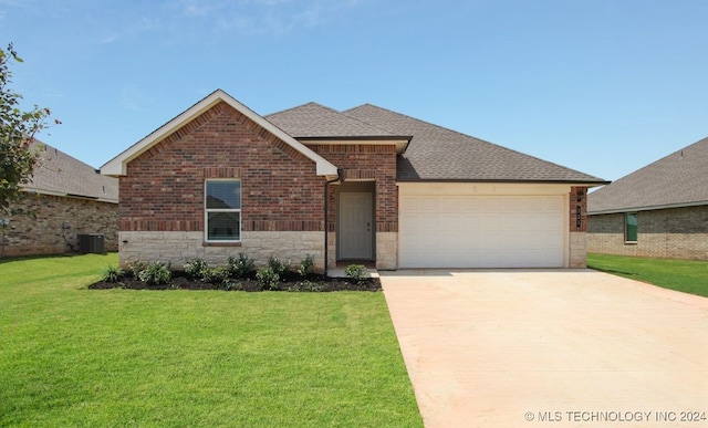 view of front of property featuring a front lawn, a garage, and cooling unit