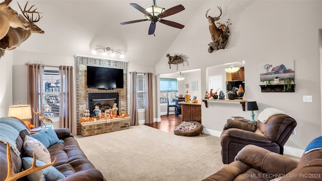 carpeted living room featuring a brick fireplace, high vaulted ceiling, and ceiling fan