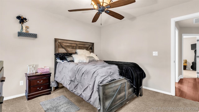 bedroom featuring light carpet and ceiling fan