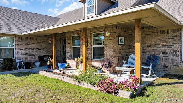 rear view of property featuring a yard and a patio area