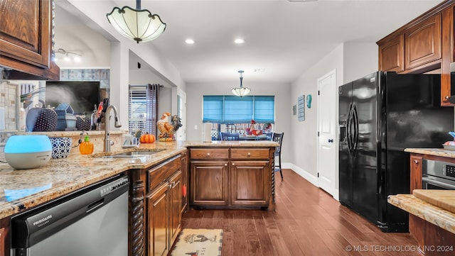 kitchen featuring sink, stainless steel appliances, dark hardwood / wood-style flooring, decorative light fixtures, and kitchen peninsula