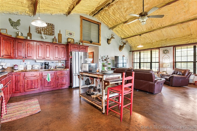 kitchen with stainless steel appliances, hanging light fixtures, high vaulted ceiling, beamed ceiling, and ceiling fan