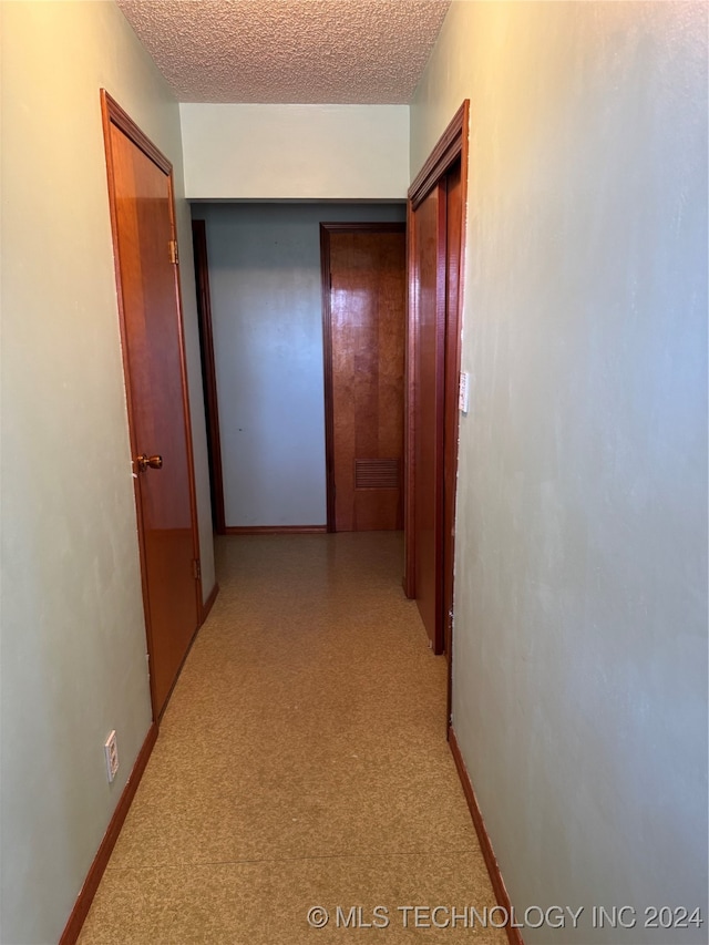 hallway featuring a textured ceiling