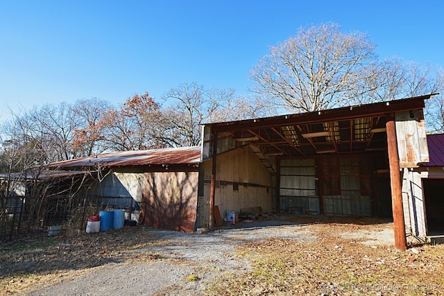 view of side of home featuring an outbuilding