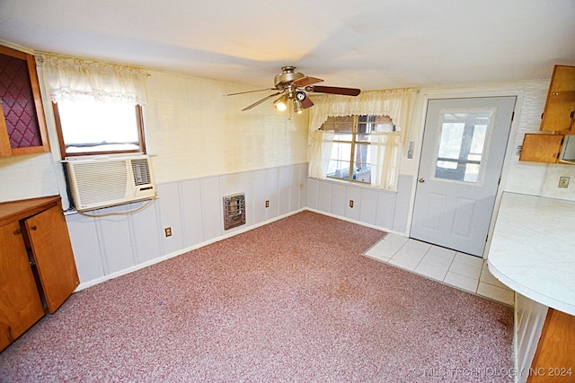 interior space with ceiling fan, plenty of natural light, and cooling unit