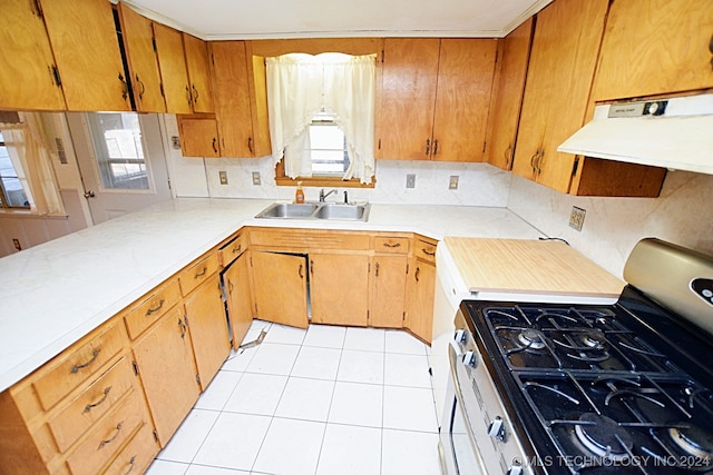 kitchen featuring range with gas cooktop, sink, ventilation hood, and light tile patterned flooring