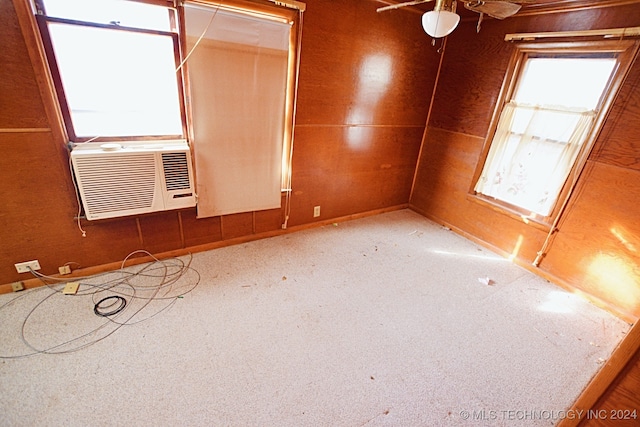 spare room with carpet, cooling unit, and ceiling fan