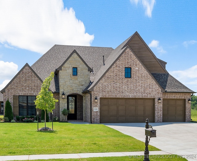 view of front of property with a garage and a front yard