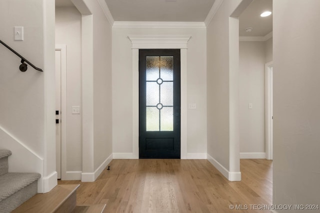 foyer featuring crown molding and light hardwood / wood-style flooring