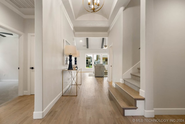 foyer featuring a chandelier, light hardwood / wood-style floors, and ornamental molding