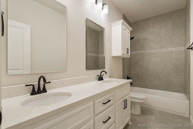 full bathroom with vanity, tile patterned flooring, toilet, and tiled shower / bath combo