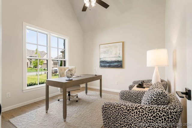 office area with ceiling fan, light wood-type flooring, and high vaulted ceiling