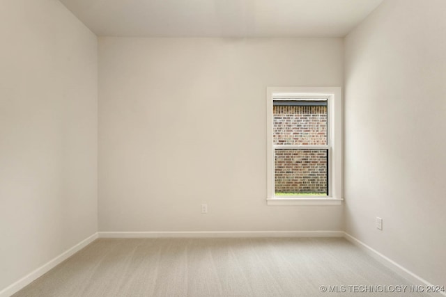 spare room with light colored carpet