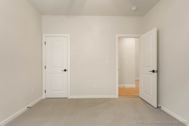 unfurnished bedroom with light carpet