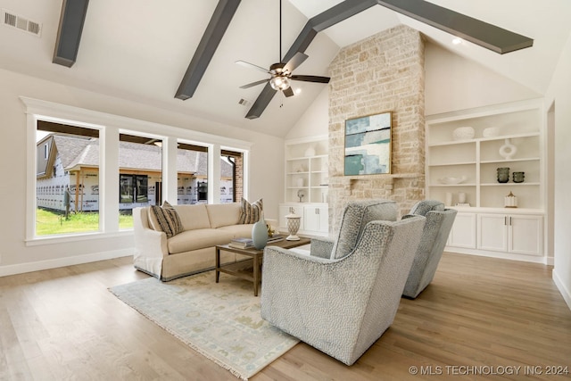 living room featuring hardwood / wood-style flooring, high vaulted ceiling, and a healthy amount of sunlight