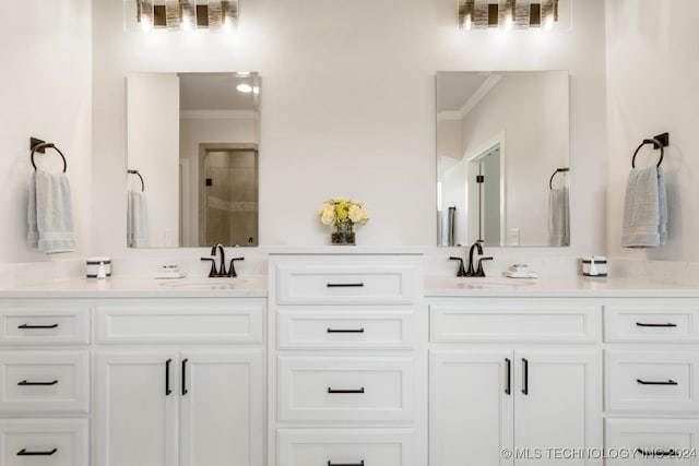 bathroom with vanity, ornamental molding, and a shower with shower door