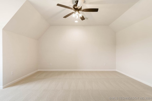 additional living space with ceiling fan, light carpet, and lofted ceiling