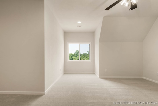 additional living space featuring light carpet and ceiling fan