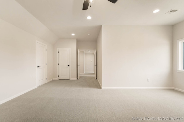 carpeted spare room featuring ceiling fan