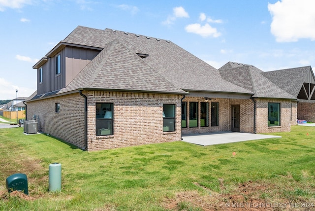 back of property featuring central AC, a lawn, and a patio