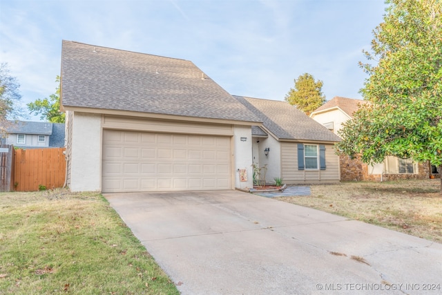 view of front of house featuring a front yard and a garage