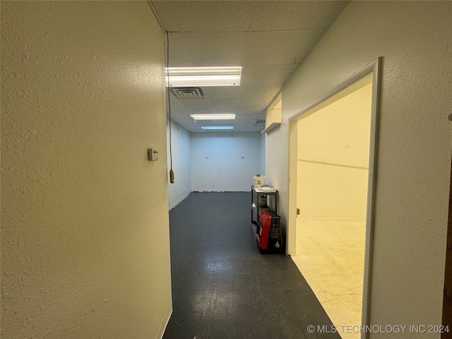 hallway featuring a drop ceiling