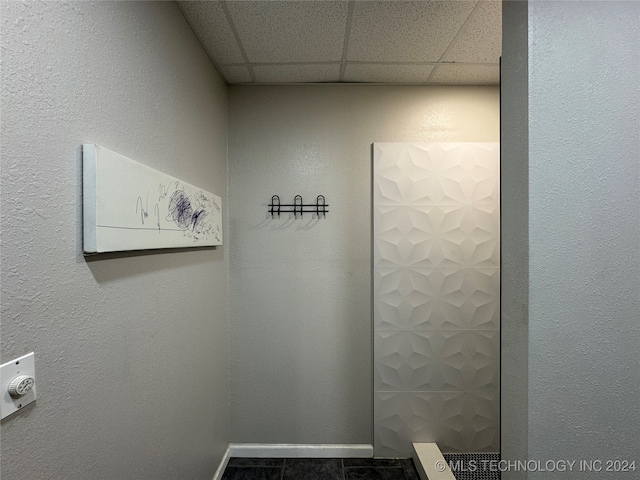 details featuring tile patterned floors and a drop ceiling