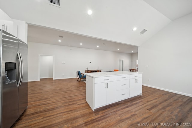 kitchen featuring stainless steel refrigerator with ice dispenser, dark hardwood / wood-style flooring, a kitchen island, and white cabinets