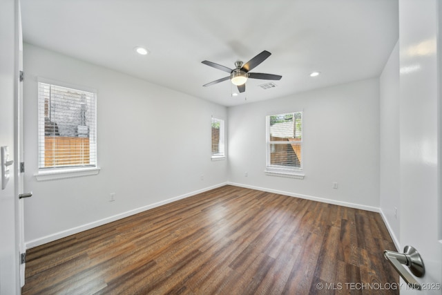 empty room with dark wood-type flooring and ceiling fan