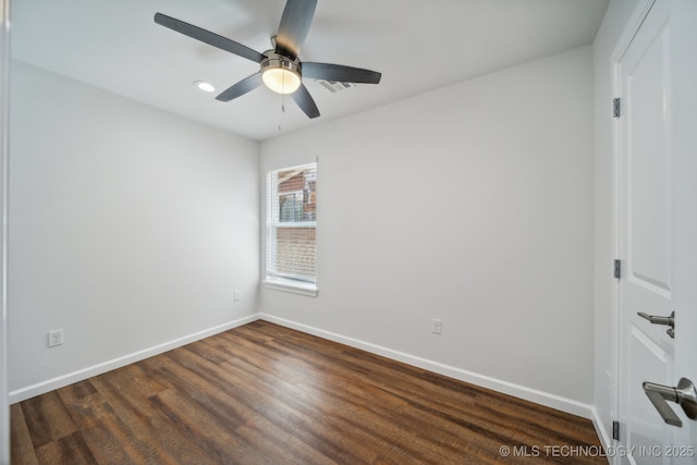 empty room with ceiling fan and dark hardwood / wood-style floors