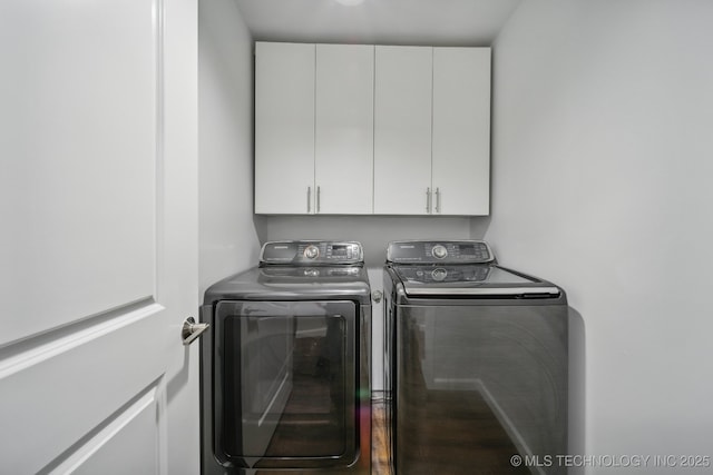 laundry room with independent washer and dryer and cabinets