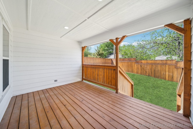 wooden terrace featuring a yard