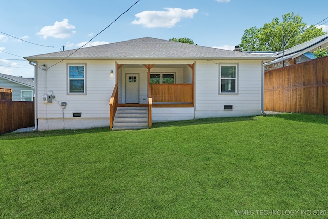 rear view of house with a lawn