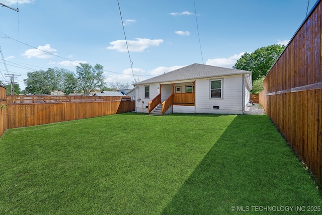 rear view of house with a yard