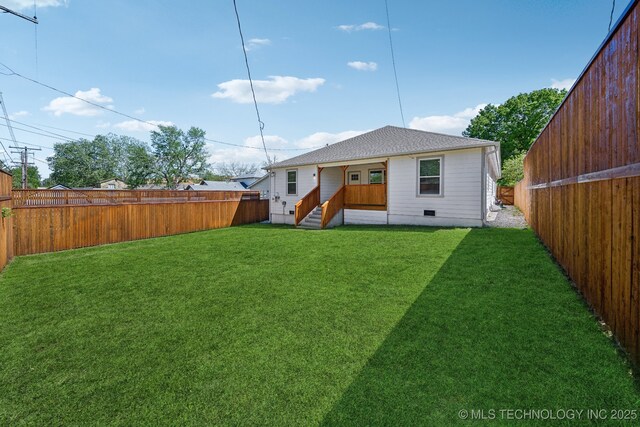 rear view of house with a yard