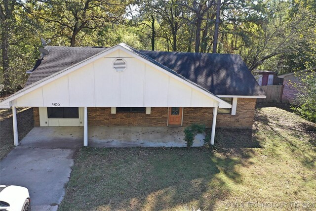 exterior space with a front lawn and a patio