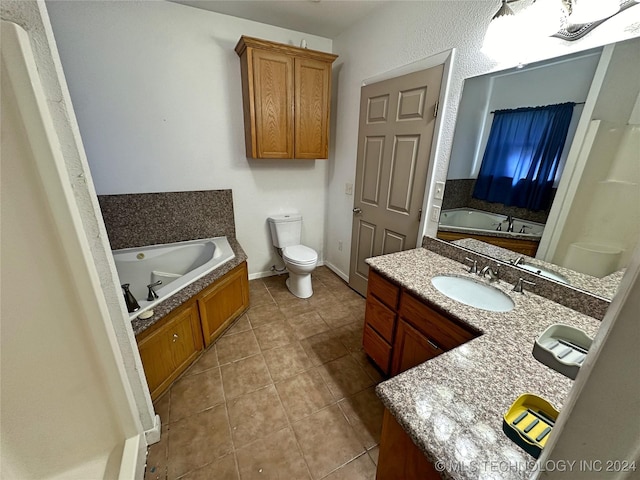 bathroom with vanity, a tub to relax in, tile patterned flooring, and toilet