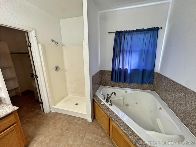 bathroom featuring tile patterned flooring, vanity, and separate shower and tub