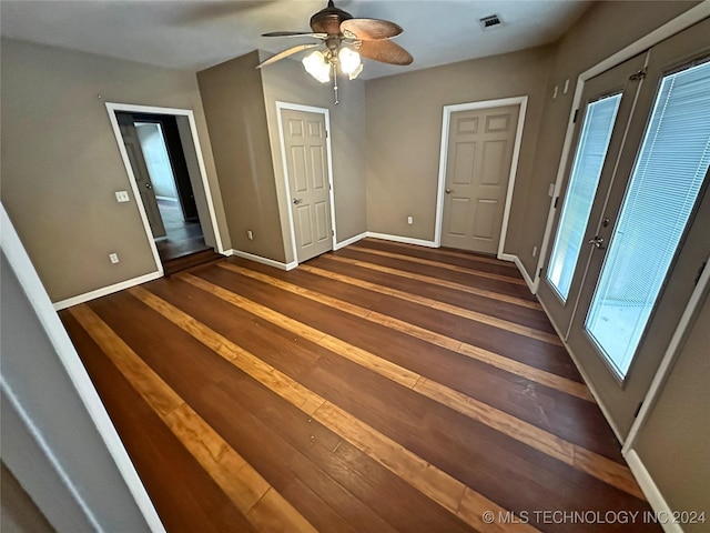 spare room with dark hardwood / wood-style floors and ceiling fan