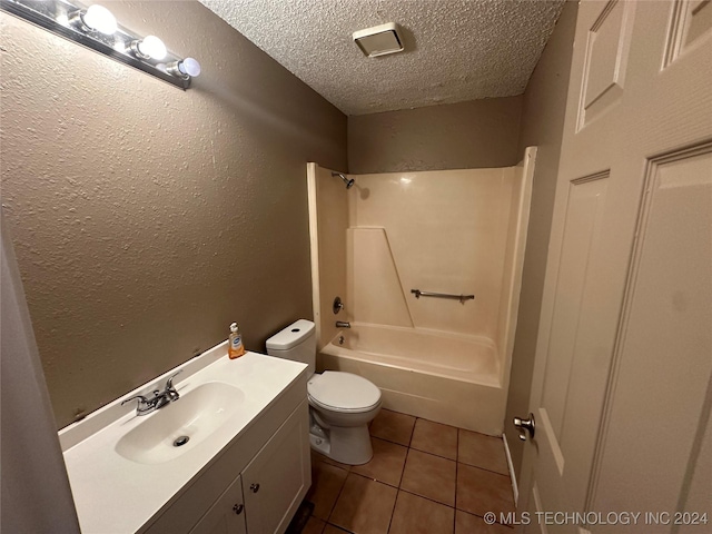 full bathroom featuring  shower combination, tile patterned flooring, vanity, a textured ceiling, and toilet