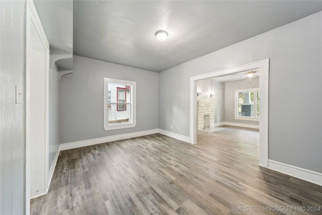 empty room with ceiling fan and light wood-type flooring