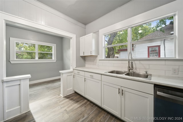 kitchen featuring dishwasher, a wealth of natural light, sink, and white cabinets