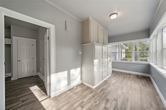 interior space featuring ornamental molding and wood-type flooring