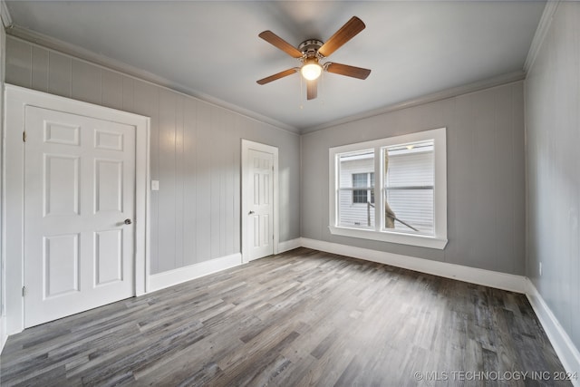 spare room with hardwood / wood-style flooring, ceiling fan, and crown molding