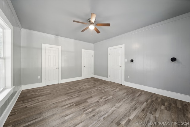 empty room with hardwood / wood-style flooring, ceiling fan, and crown molding