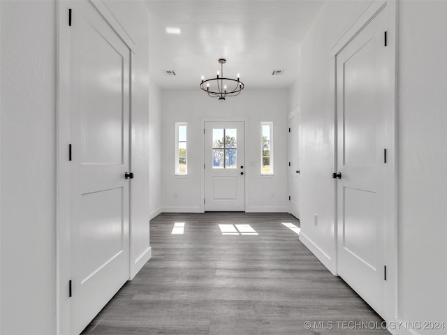 entrance foyer with light hardwood / wood-style floors and an inviting chandelier