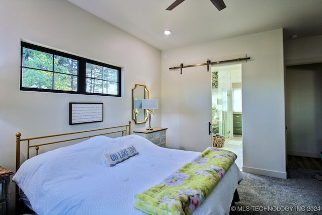 carpeted bedroom featuring a barn door and ceiling fan