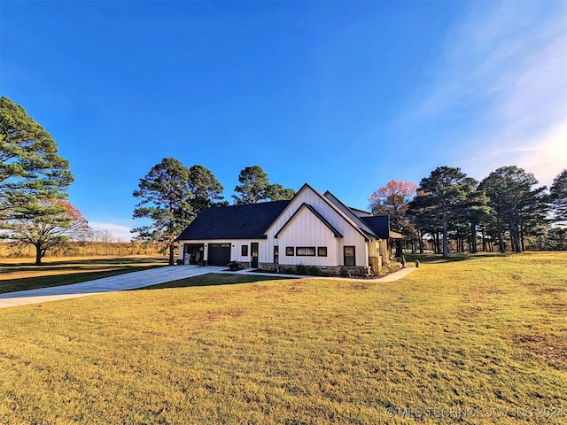 modern farmhouse featuring a garage and a front lawn